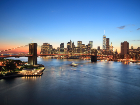 View of Lower Manhattan skyline and Brooklyn Bridge at sunset, New York, USA